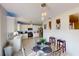 Bright eat-in kitchen featuring white cabinets, stainless steel appliances, and a cozy dining area for casual meals and gatherings at 3044 Camino Real S Dr, Kissimmee, FL 34744