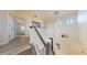 Second floor landing with chandelier and views of the foyer and front entry at 3044 Camino Real S Dr, Kissimmee, FL 34744