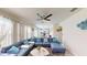 Bright living room with a large sectional couch and large windows that offer ample natural light and create a welcoming atmosphere at 3044 Camino Real S Dr, Kissimmee, FL 34744