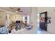 Open-concept living and dining area with wood floors, ceiling fan, and modern furnishings, ideal for entertaining and Gathering living at 3044 Camino Real S Dr, Kissimmee, FL 34744
