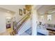 View of the staircase with a bathroom on the left and view into the living room at 3044 Camino Real S Dr, Kissimmee, FL 34744