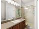 Bathroom featuring a shower with glass doors, vanity and shower head at 3331 Windsor Lake Cir, Sanford, FL 32773