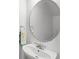 Bathroom featuring a stylish round mirror and modern faucet at 3331 Windsor Lake Cir, Sanford, FL 32773