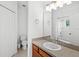 Well-lit bathroom with a vanity, toilet and shower at 3331 Windsor Lake Cir, Sanford, FL 32773