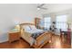 Bright bedroom features a ceiling fan, wood floors, and charming décor at 3331 Windsor Lake Cir, Sanford, FL 32773