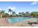 Large community pool surrounded by lounge chairs, palm trees, and secure fencing at 3331 Windsor Lake Cir, Sanford, FL 32773