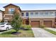 Two-story townhome featuring a landscaped yard, attached two-car garage, and private front entrance at 3331 Windsor Lake Cir, Sanford, FL 32773