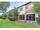 A view of the rear of this multi-Gathering property featuring screen porches and well-maintained landscaping at 3331 Windsor Lake Cir, Sanford, FL 32773