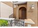 Charming front entrance with dark wood door, arched entryway, and decorative exterior lighting at 3331 Windsor Lake Cir, Sanford, FL 32773