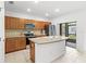 Spacious kitchen with a large island, stainless steel appliances, and view to outdoor living area at 3331 Windsor Lake Cir, Sanford, FL 32773