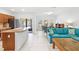 Open-concept living space with tiled floors, modern furniture, and a view of the backyard at 3331 Windsor Lake Cir, Sanford, FL 32773