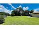 Large backyard with well-maintained lawn and mature trees, creating a serene setting at 3443 Wild Myrtle Ct, Windermere, FL 34786