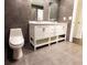 Bathroom with double sink, marble countertops, modern tile floors, and a separate toilet area at 3443 Wild Myrtle Ct, Windermere, FL 34786