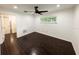 Bedroom with dark wood tile flooring, ceiling fan, and an easily accessible door to the hallway at 3443 Wild Myrtle Ct, Windermere, FL 34786
