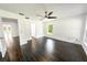 Bright bedroom with dark wood floors, ceiling fan, and natural light from the window at 3443 Wild Myrtle Ct, Windermere, FL 34786