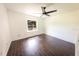 Bedroom featuring fan, window overlooking the backyard, and dark wood-look tile floors at 3443 Wild Myrtle Ct, Windermere, FL 34786