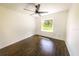 Bedroom featuring fan, window overlooking the yard, and dark wood-look tile floors at 3443 Wild Myrtle Ct, Windermere, FL 34786