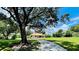Charming home with a long driveway, lush landscaping, and a canopy of mature trees at 3443 Wild Myrtle Ct, Windermere, FL 34786