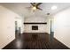 Spacious living room with a stunning brick fireplace and dark wood floors, perfect for relaxing at 3443 Wild Myrtle Ct, Windermere, FL 34786