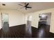 Open-concept living area with dark wood flooring and bright, neutral walls at 3443 Wild Myrtle Ct, Windermere, FL 34786