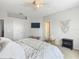 Well-lit bedroom with TV, woven decor, and comfortable carpeted floor at 348 Sigmund Loop, Davenport, FL 33837