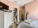 Bright bedroom with walk-in closet, white dresser, and wood flooring at 348 Sigmund Loop, Davenport, FL 33837