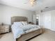 Neutral bedroom with bedside tables, carpet, and bed facing an open doorway to another room at 348 Sigmund Loop, Davenport, FL 33837