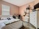 Bright bedroom features stylish decor, dresser and wood flooring at 348 Sigmund Loop, Davenport, FL 33837