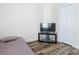 Simple bedroom design featuring TV, wood flooring and natural light at 348 Sigmund Loop, Davenport, FL 33837