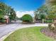 Gated community entrance with lush greenery and brick pillars, offering security and curb appeal at 348 Sigmund Loop, Davenport, FL 33837