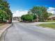 Landscaped gated entrance to the community, with mature trees and manicured shrubs providing a welcoming feel at 348 Sigmund Loop, Davenport, FL 33837