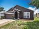 Charming single-story home with a well-maintained lawn, attached garage, and attractive curb appeal at 348 Sigmund Loop, Davenport, FL 33837