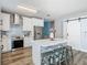 Bright kitchen with stainless steel appliances, island, and white sliding barn door at 348 Sigmund Loop, Davenport, FL 33837