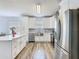 Bright, modern kitchen with stainless steel appliances, island, and white cabinetry at 348 Sigmund Loop, Davenport, FL 33837