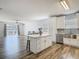 Bright, modern kitchen with stainless steel appliances, island, and white cabinetry at 348 Sigmund Loop, Davenport, FL 33837