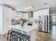 Bright, modern kitchen with stainless steel appliances, island, and white cabinetry at 348 Sigmund Loop, Davenport, FL 33837