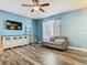 Inviting living space with hardwood floors, TV, and modern décor for a comfortable ambiance at 348 Sigmund Loop, Davenport, FL 33837