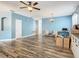 Comfortable living area with hardwood flooring, blue walls, and stylish furnishings at 348 Sigmund Loop, Davenport, FL 33837