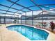 Relaxing screened-in pool area with stylish landscaping provides a private oasis for leisure and recreation at 348 Sigmund Loop, Davenport, FL 33837