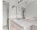 Bathroom vanity with a sleek countertop, large mirror, and white cabinets at 351 Cloverdale Rd, Winter Haven, FL 33884
