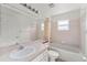 Well-lit bathroom with a shower-tub combo, vanity with white cabinets, and a large mirror at 351 Cloverdale Rd, Winter Haven, FL 33884