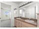 Bathroom with a double sink vanity and views into primary bedroom at 351 Cloverdale Rd, Winter Haven, FL 33884