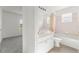 Bathroom with a shower-tub combo, vanity with white cabinets, and natural light at 351 Cloverdale Rd, Winter Haven, FL 33884