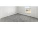 Bedroom with neutral paint, carpeted floor, and a window overlooking the yard at 351 Cloverdale Rd, Winter Haven, FL 33884