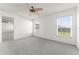 Bright bedroom with ceiling fan and neutral carpet at 351 Cloverdale Rd, Winter Haven, FL 33884