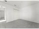 A large bedroom with white walls and a view into the hallway at 351 Cloverdale Rd, Winter Haven, FL 33884
