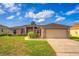 Charming single-Gathering home with manicured lawn and attached two-car garage on a sunny day at 351 Cloverdale Rd, Winter Haven, FL 33884