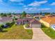 Charming single-story home with a well-maintained lawn and a two-car garage at 351 Cloverdale Rd, Winter Haven, FL 33884