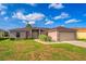 Charming home with a two-car garage, a well-manicured lawn, and mature landscaping at 351 Cloverdale Rd, Winter Haven, FL 33884