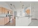 Bright kitchen features stainless steel appliances, tiled floors and breakfast bar at 351 Cloverdale Rd, Winter Haven, FL 33884